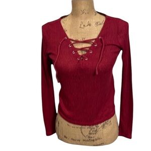 Raspberry colored long sleeve shirt with lace up front.